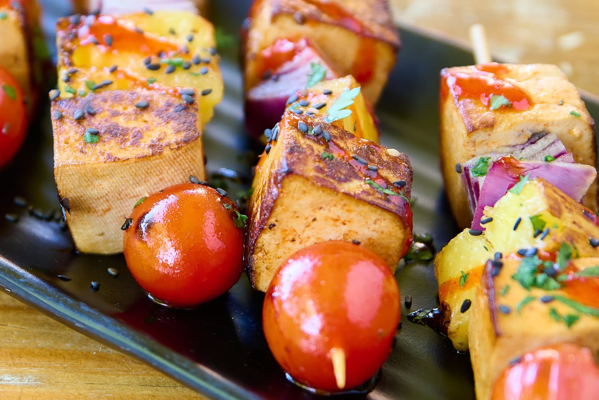 Grilled tofu, pineapple, red onion and cherry tomato skewers